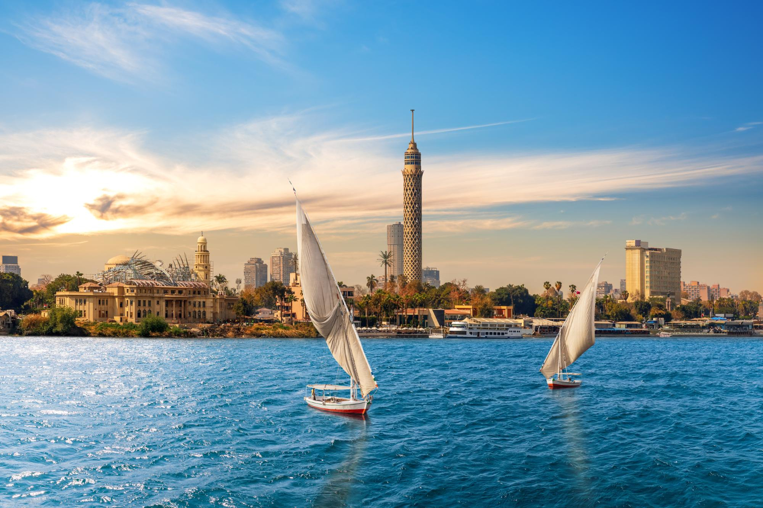 The Nile and feluccas in front of the Tower of Cairo Egypt